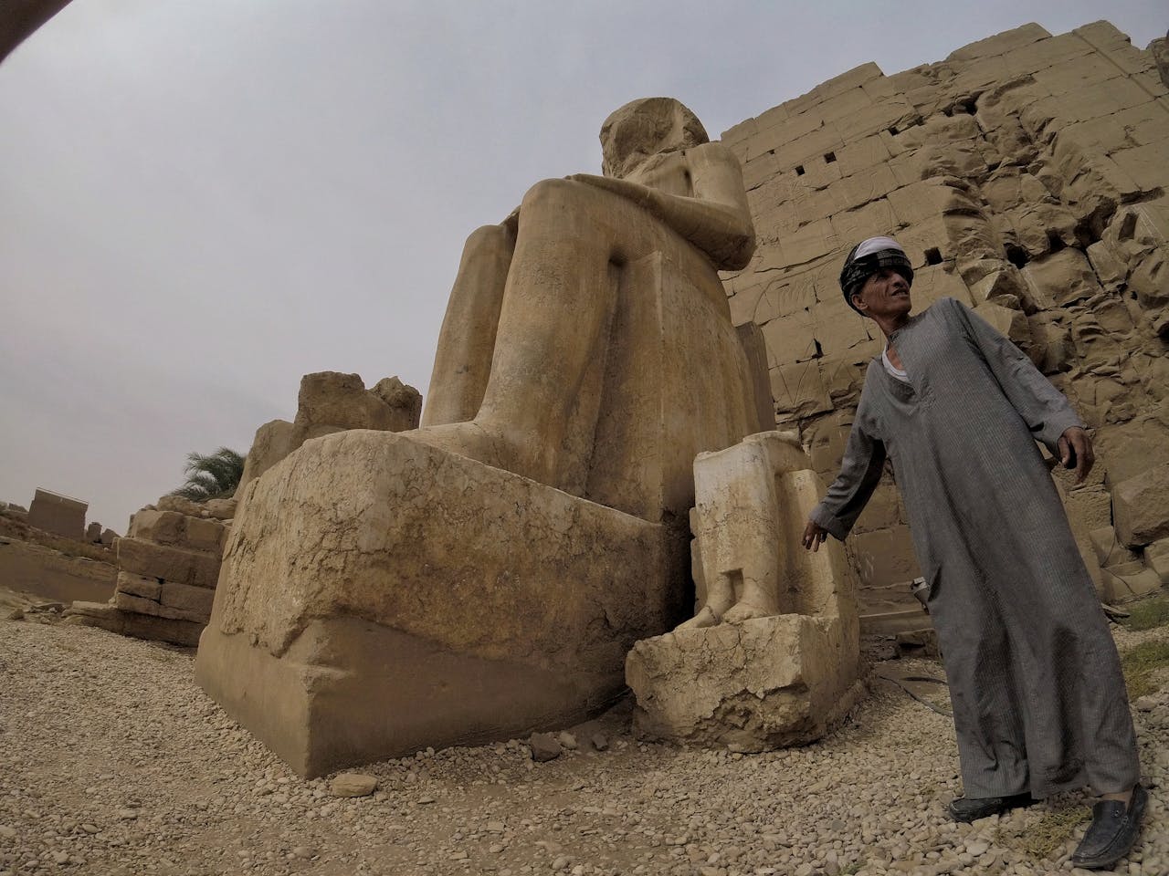 portfolio-03 Tourist guide points to an ancient statue at Karnak Temple in Luxor, Egypt.